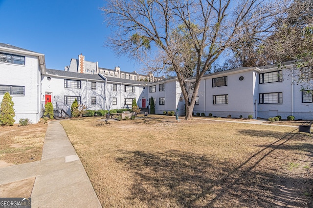 view of property's community with a lawn