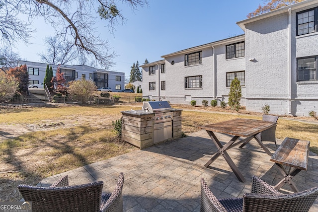 view of patio with area for grilling and exterior kitchen