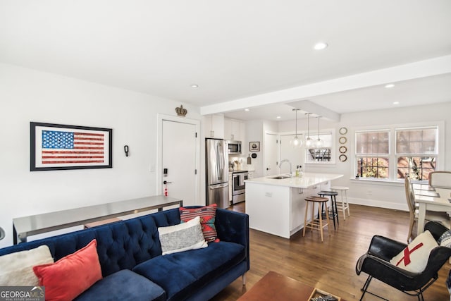 living room with dark wood-type flooring and sink