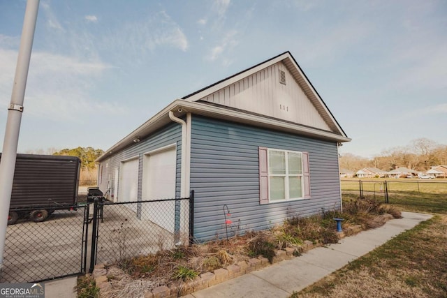 view of side of home with an outdoor structure and a garage