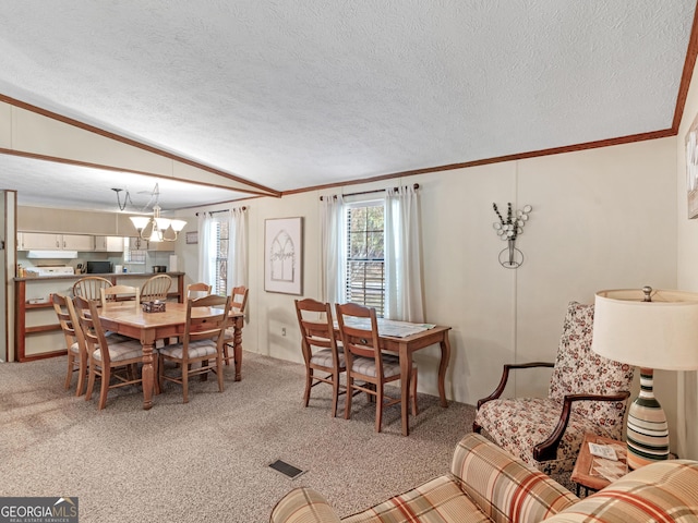 dining space with carpet, lofted ceiling, and a textured ceiling