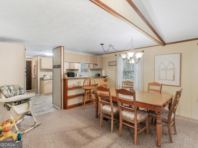 dining area with lofted ceiling, light colored carpet, a textured ceiling, and an inviting chandelier