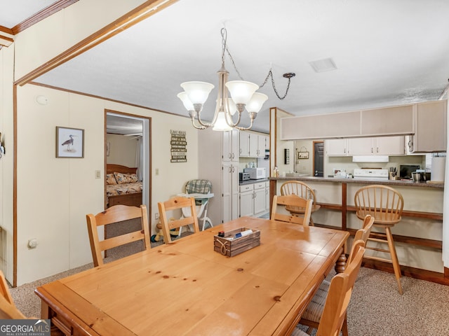 dining space with crown molding and a notable chandelier