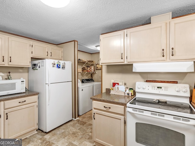 kitchen featuring a textured ceiling, white appliances, and washing machine and dryer