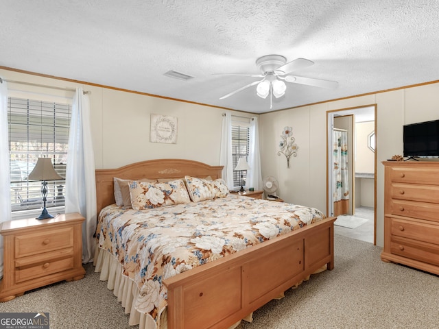 carpeted bedroom featuring a textured ceiling and ceiling fan