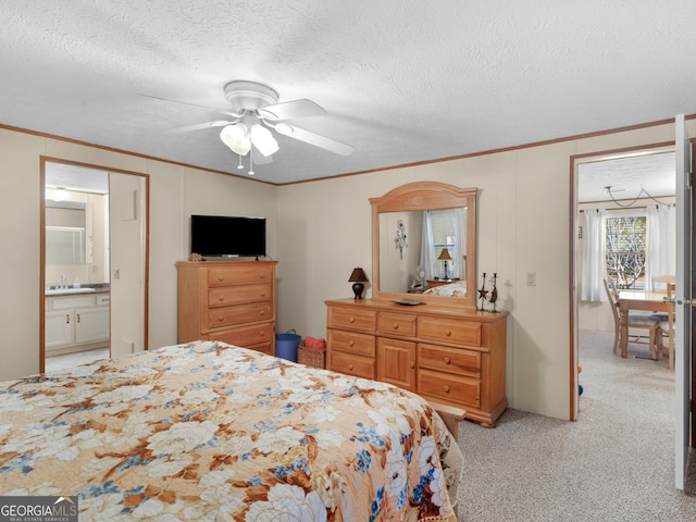 carpeted bedroom featuring ensuite bath, ceiling fan, sink, and a textured ceiling