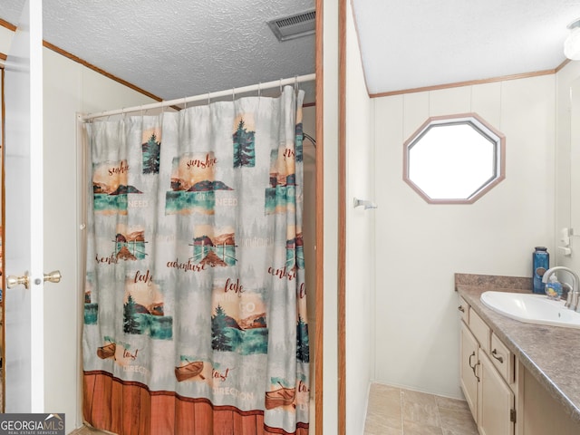 bathroom with a shower with curtain, vanity, a textured ceiling, and ornamental molding