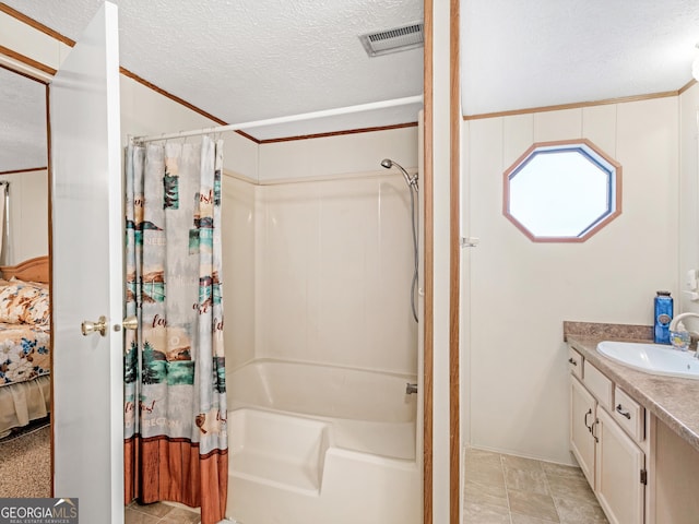 bathroom featuring vanity, shower / tub combo, a textured ceiling, and ornamental molding