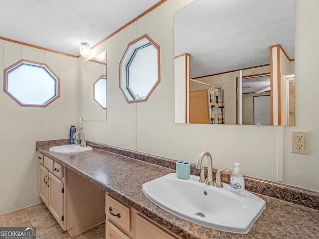 bathroom featuring a shower with shower curtain, vanity, crown molding, and a textured ceiling