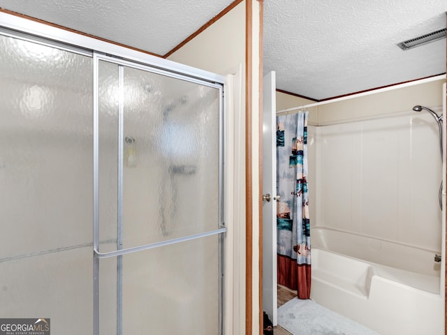 bathroom featuring crown molding, a textured ceiling, and walk in shower