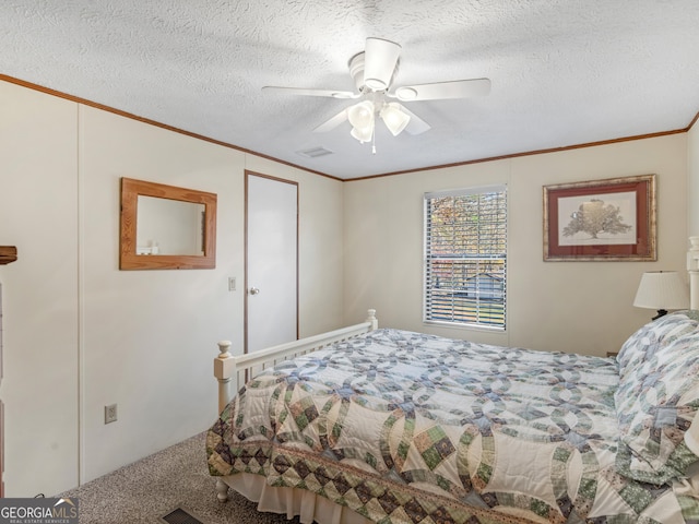 bedroom featuring ceiling fan, crown molding, carpet floors, and a textured ceiling