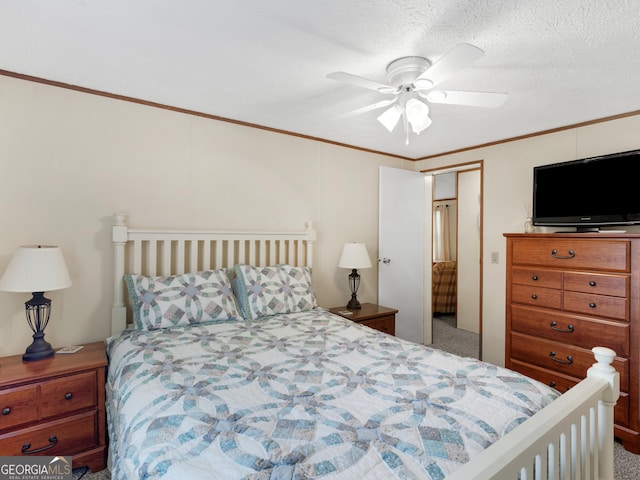 carpeted bedroom with ceiling fan, a closet, a textured ceiling, and ornamental molding