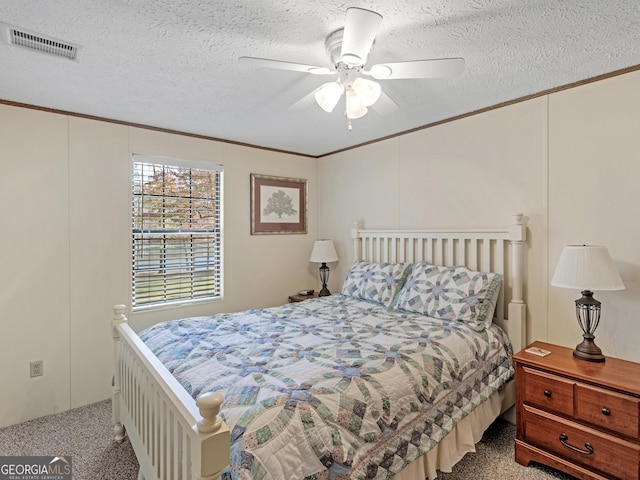 carpeted bedroom featuring ceiling fan, crown molding, and a textured ceiling