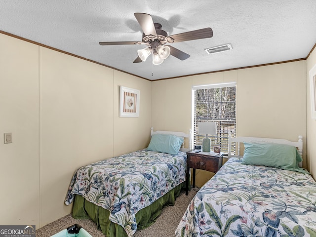 carpeted bedroom featuring ceiling fan, crown molding, and a textured ceiling