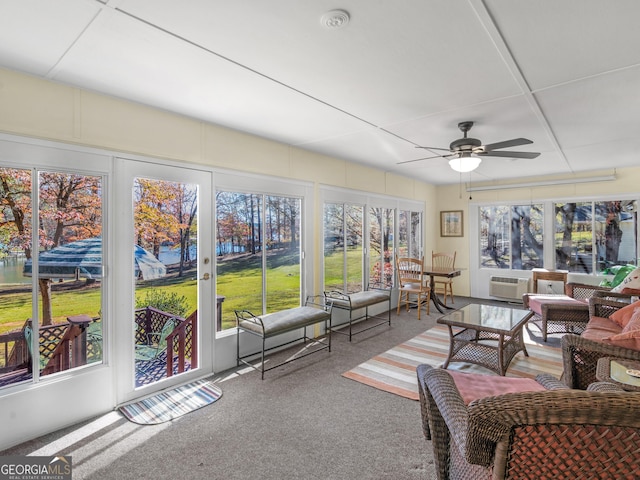 sunroom / solarium featuring ceiling fan