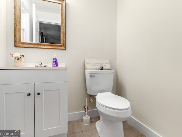 bathroom with tile patterned flooring, vanity, and toilet