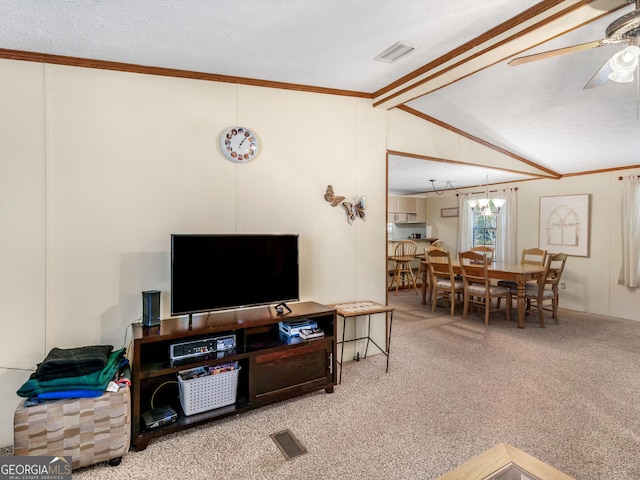 living room with a textured ceiling, vaulted ceiling, and crown molding