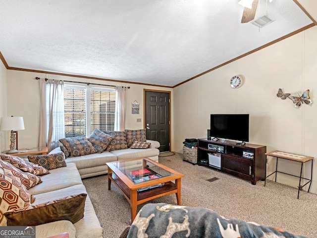 living room featuring carpet, a textured ceiling, ceiling fan, and crown molding