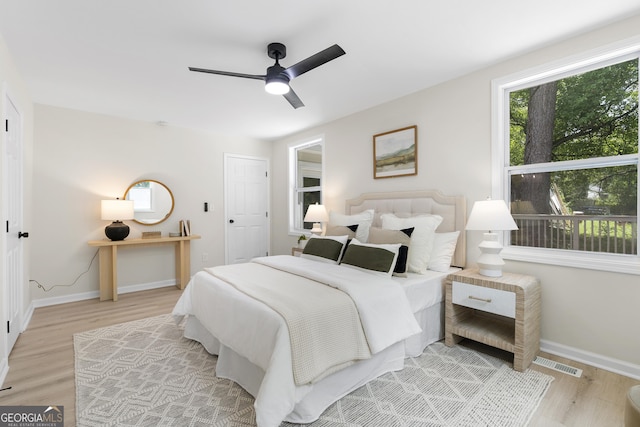 bedroom with ceiling fan and light hardwood / wood-style floors