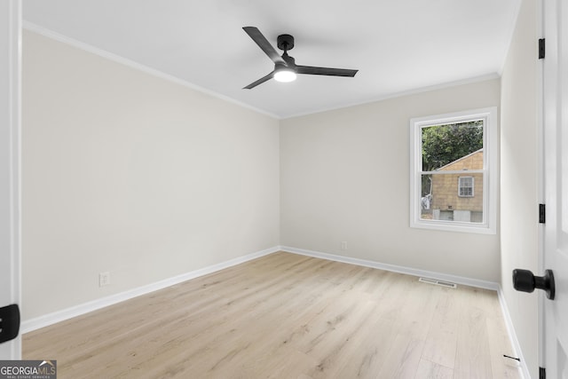 spare room with light wood-type flooring, ceiling fan, and crown molding