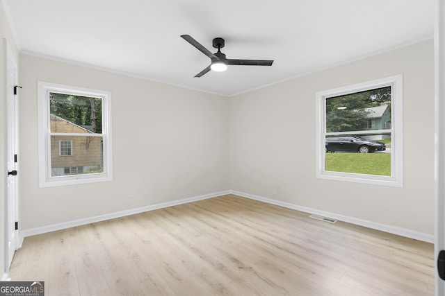 spare room featuring ceiling fan, light hardwood / wood-style floors, and ornamental molding