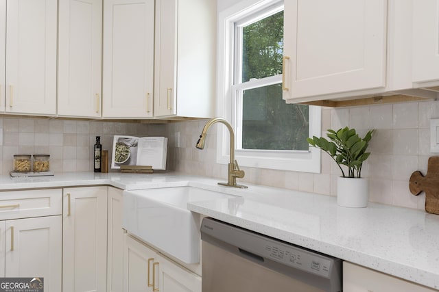 kitchen with dishwasher, white cabinetry, and light stone countertops