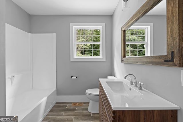 bathroom featuring hardwood / wood-style floors, vanity, toilet, and a wealth of natural light