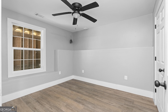 unfurnished room featuring ceiling fan and hardwood / wood-style flooring