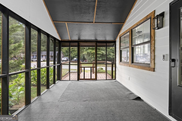 unfurnished sunroom featuring vaulted ceiling