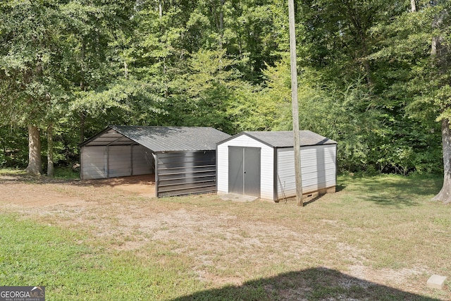 view of outbuilding with a carport and a yard