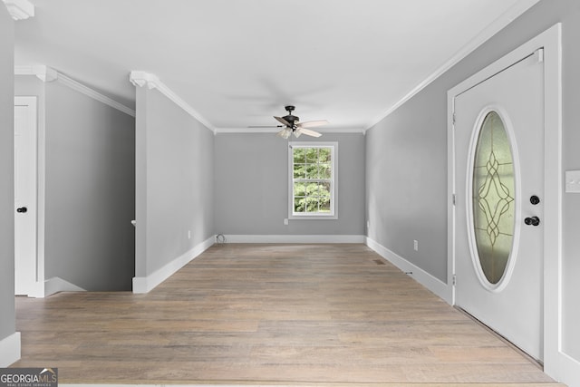 foyer featuring ceiling fan, light wood-type flooring, and crown molding