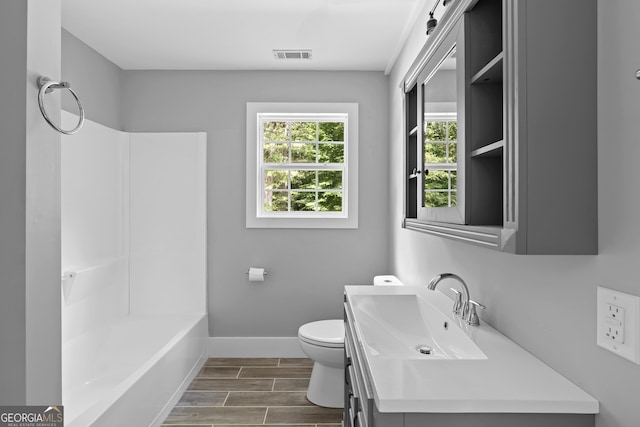 full bathroom with toilet, vanity,  shower combination, and hardwood / wood-style flooring