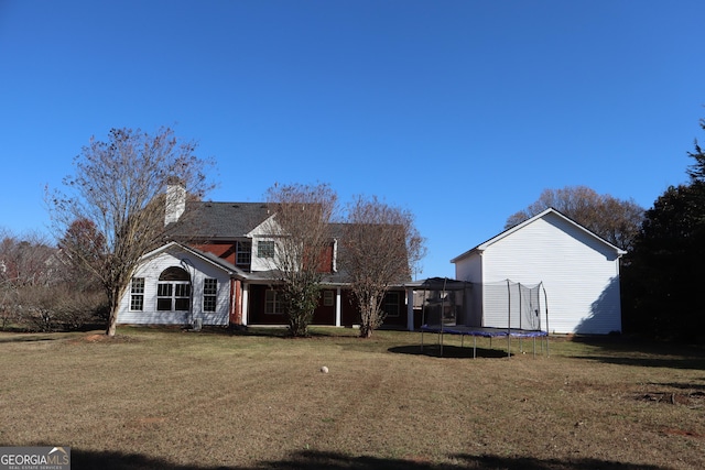 view of front of property featuring a front lawn and a trampoline