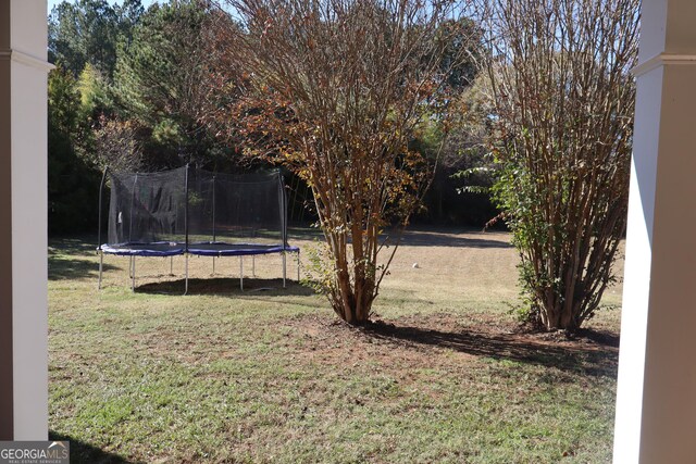 view of yard featuring a trampoline