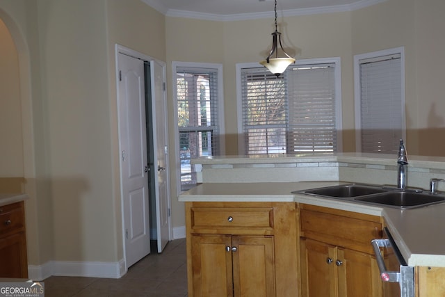 kitchen with dishwasher, sink, tile patterned floors, crown molding, and pendant lighting