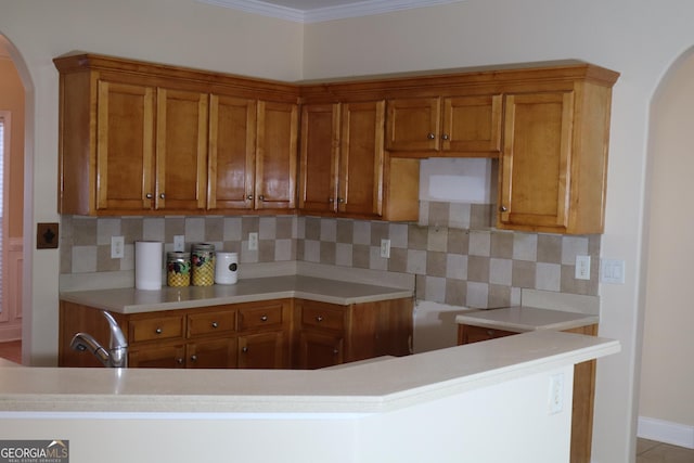 kitchen featuring backsplash, sink, and crown molding