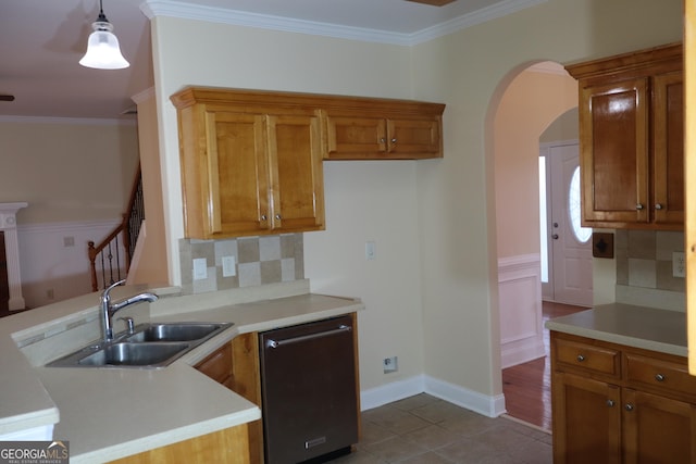 kitchen featuring backsplash, ornamental molding, sink, dishwasher, and hanging light fixtures