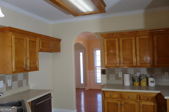 kitchen featuring dishwasher, tasteful backsplash, ornamental molding, and light hardwood / wood-style floors