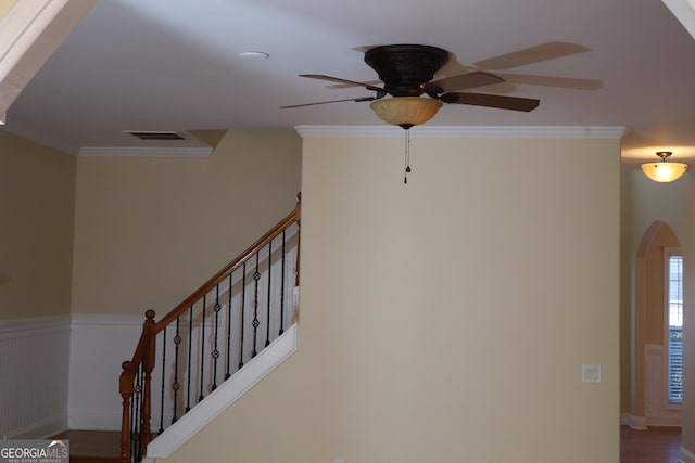 stairs with hardwood / wood-style flooring, ceiling fan, and crown molding