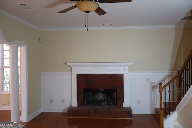 unfurnished living room featuring dark hardwood / wood-style floors, ceiling fan, ornamental molding, and a fireplace