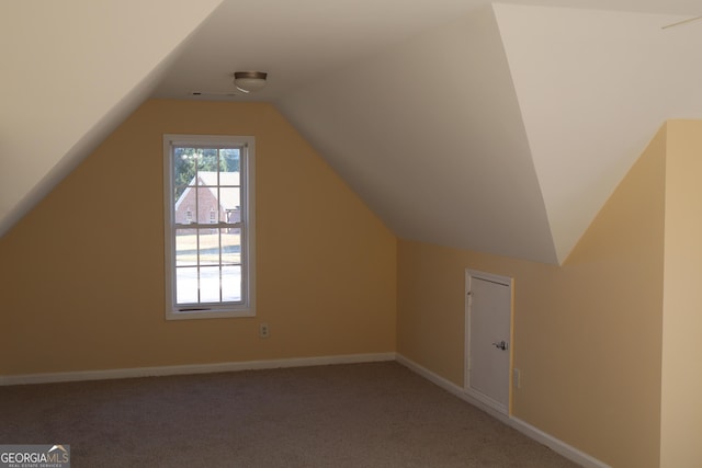 bonus room featuring carpet floors and vaulted ceiling