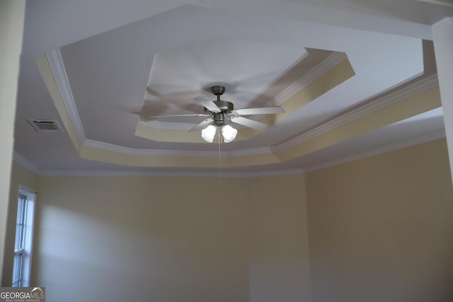 details with ceiling fan, ornamental molding, and a tray ceiling