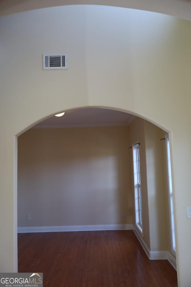 unfurnished room featuring dark wood-type flooring