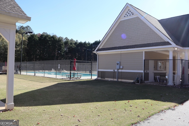 view of pool with a yard