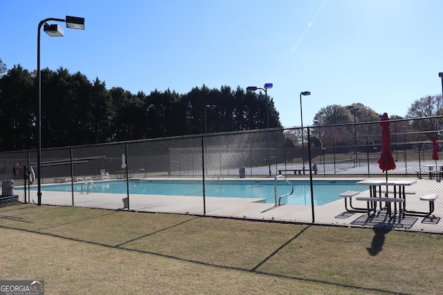 view of swimming pool with a patio area and a yard