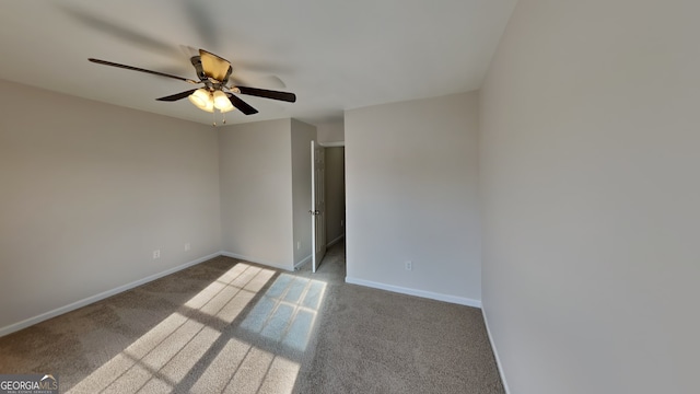 unfurnished room with light colored carpet and ceiling fan