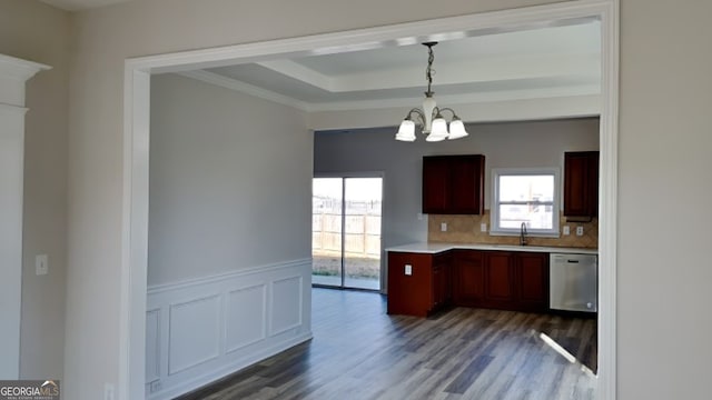 kitchen with dark hardwood / wood-style flooring, tasteful backsplash, sink, pendant lighting, and dishwasher