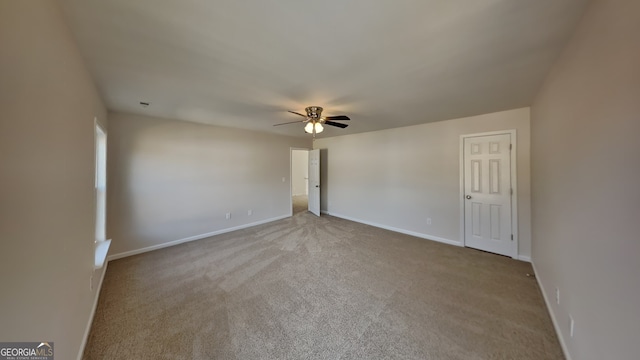 carpeted spare room with ceiling fan