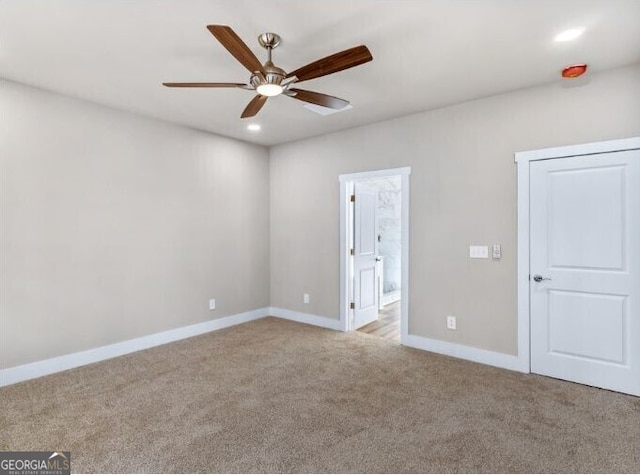 carpeted empty room with ceiling fan