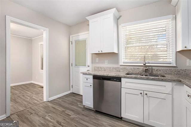 kitchen featuring dishwasher, sink, hardwood / wood-style flooring, light stone countertops, and white cabinetry